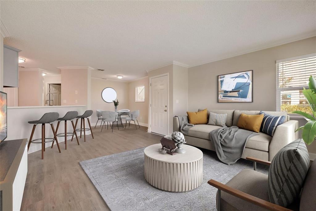 A living room and dining area feature light wood flooring, neutral walls, and modern furniture — 2556 WOODGATE BOULEVARD UNIT 101, ORLANDO, FL