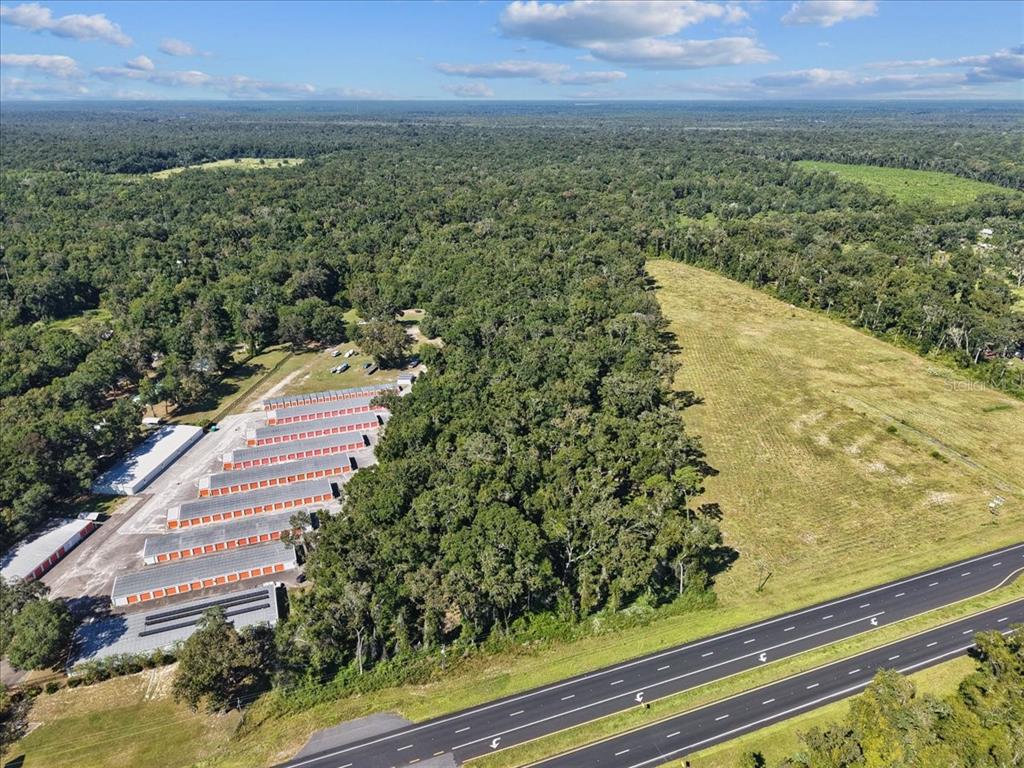 An aerial view shows a storage facility complex adjacent to a large field and highway — NW US 19 HIGHWAY, FANNING SPRINGS, FL