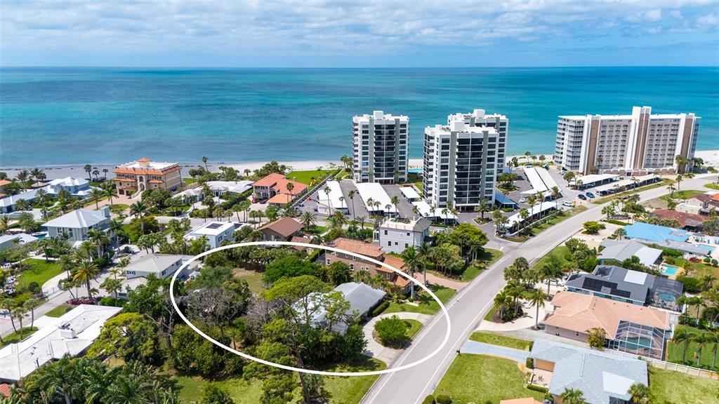An aerial view shows a residential property circled in white near a coastal beach area — 621 ALHAMBRA ROAD, VENICE, FL