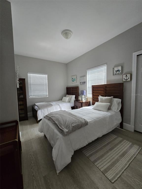 A bathroom features a vessel sink, a round dark-framed mirror, and a glass-enclosed shower — 244 LEXINGTON DRIVE, DAYTONA BEACH, FL