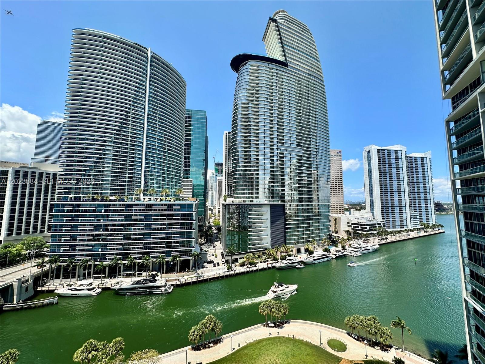 An elevated view of a canal with yachts and modern high-rise buildings in Miami — 475 Brickell Avenue # 1614, Miami FL 33131, MIAMI, FL