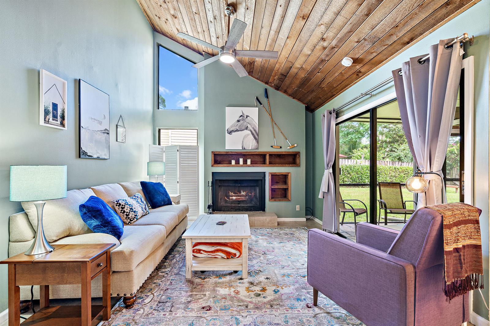 A living room features a vaulted wood ceiling, a fireplace, and a sliding glass door — 500 Oak Shadow Way, Wellington FL 33414, WELLINGTON, FL