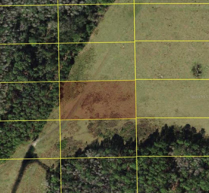 This is an aerial map view showing a highlighted rectangular plot of land — POLK CITY, POLK CITY, FL