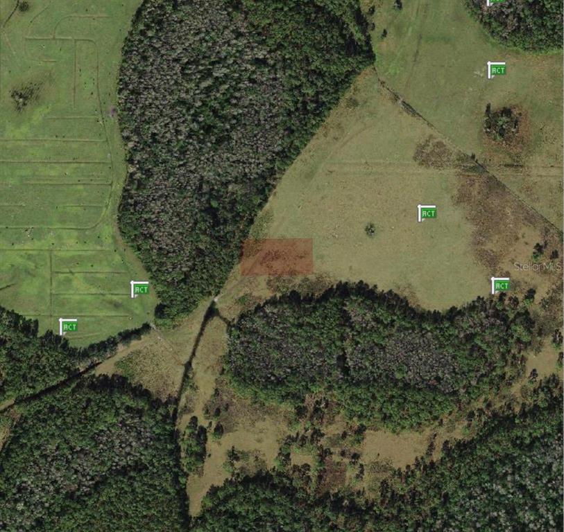 This is an aerial map view of a rural plot of land with wooded areas — POLK CITY, POLK CITY, FL