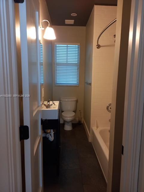 A narrow bathroom features a pedestal sink, a toilet, and a shower-tub combination with tile — 119 Cibao Ct # 3, Coral Gables FL 33134, CORAL GABLES, FL