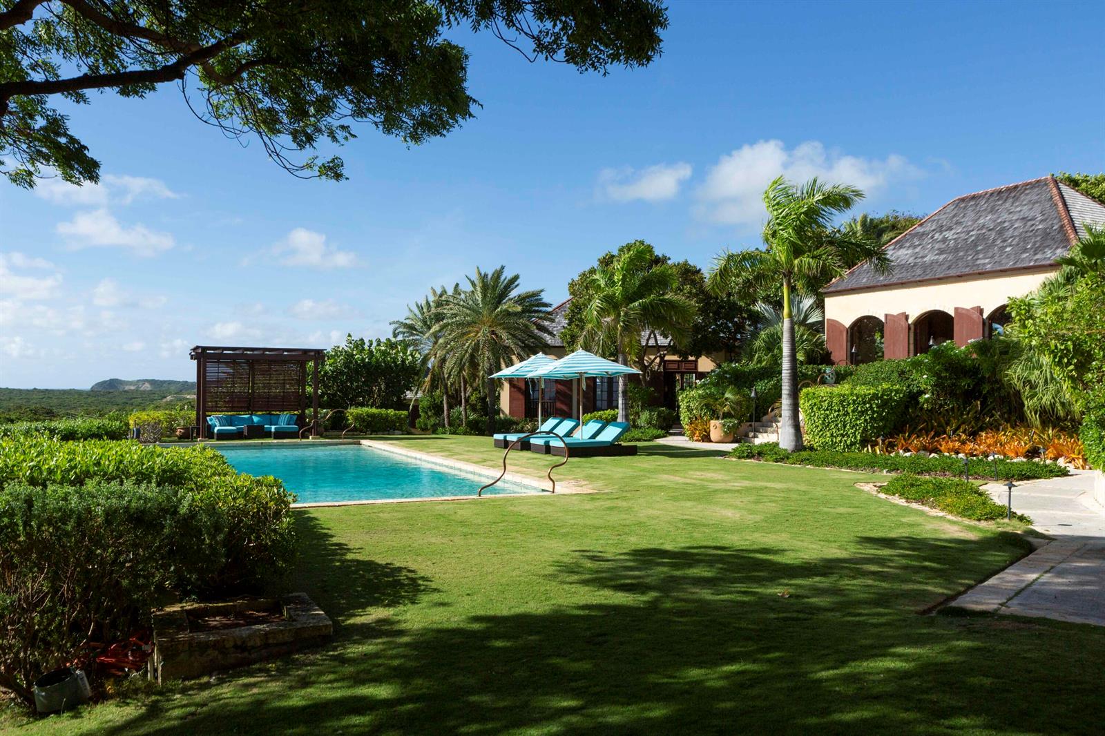 A swimming pool with a wooden pergola and lounge chairs sits on a grassy lawn — 0 Pelican Ridge, FL