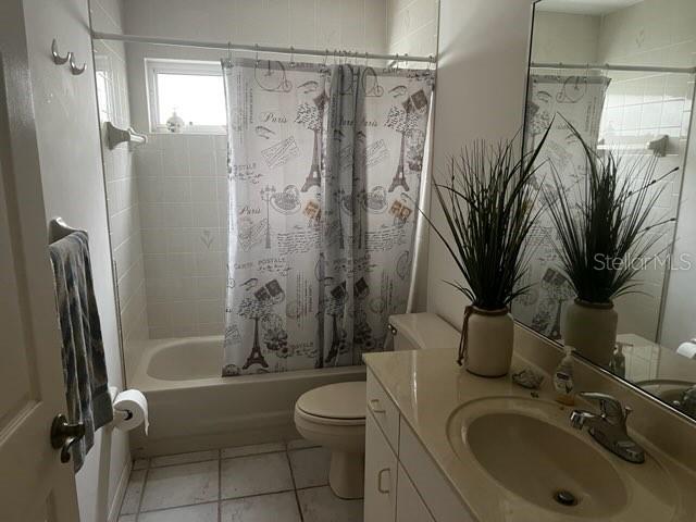 A bathroom featuring a shower-tub combination, a toilet, and a vanity with a sink — 8407 OAK JAY LANE, ENGLEWOOD, FL