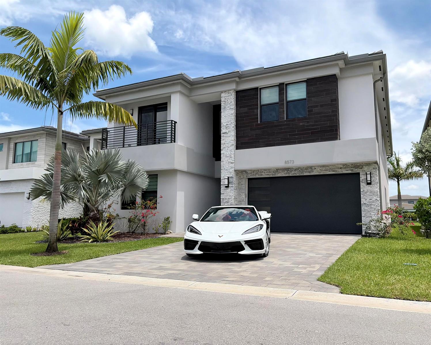 A white sports car is parked in the driveway of a modern two-story suburban home — 8573 Crystal Downs Avenue, Boca Raton FL 33434, BOCA RATON, FL