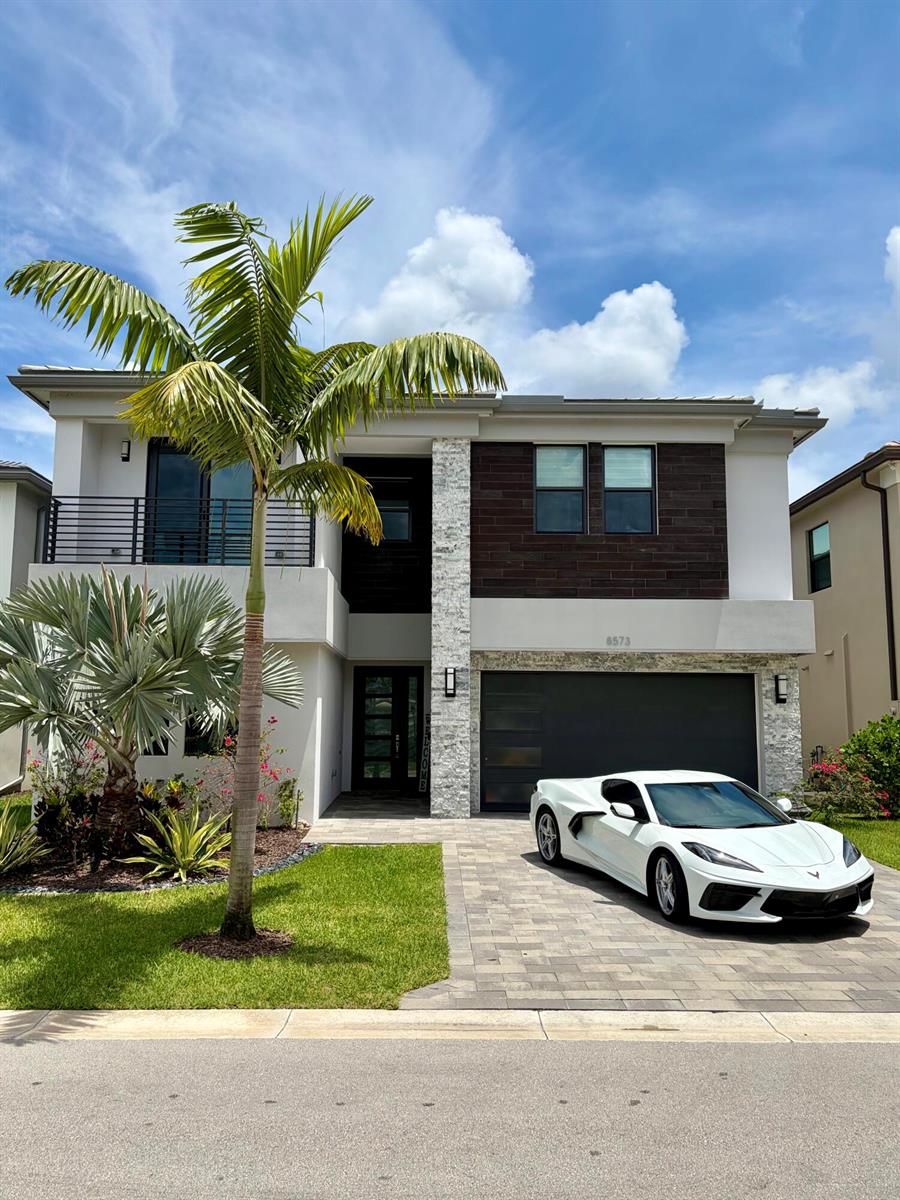 A modern two-story house with a white sports car parked in the paved driveway — 8573 Crystal Downs Avenue, Boca Raton FL 33434, BOCA RATON, FL