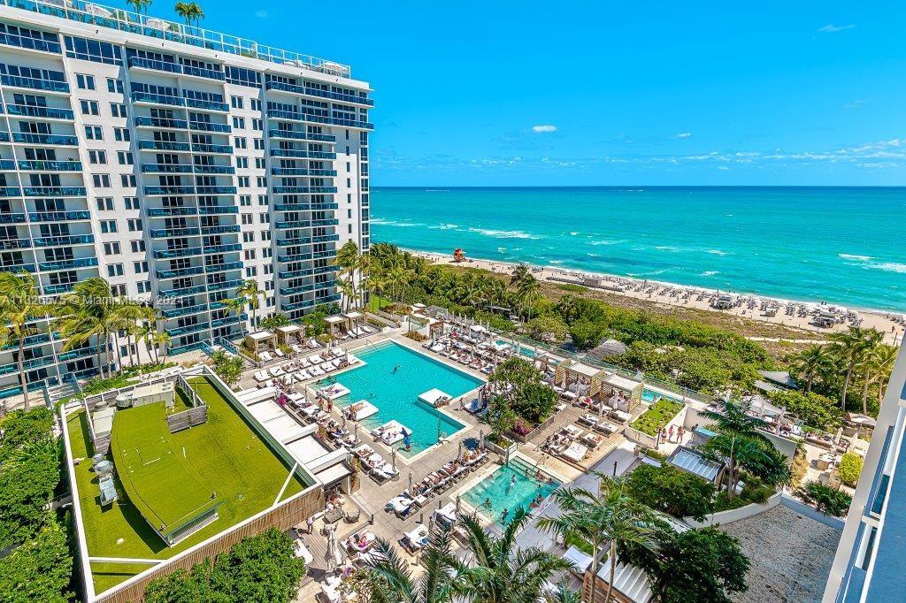 An aerial view of a high-rise building with a swimming pool deck overlooking the beach — 2301 Collins Ave # 1117, Miami Beach FL 33139, MIAMI BEACH, FL