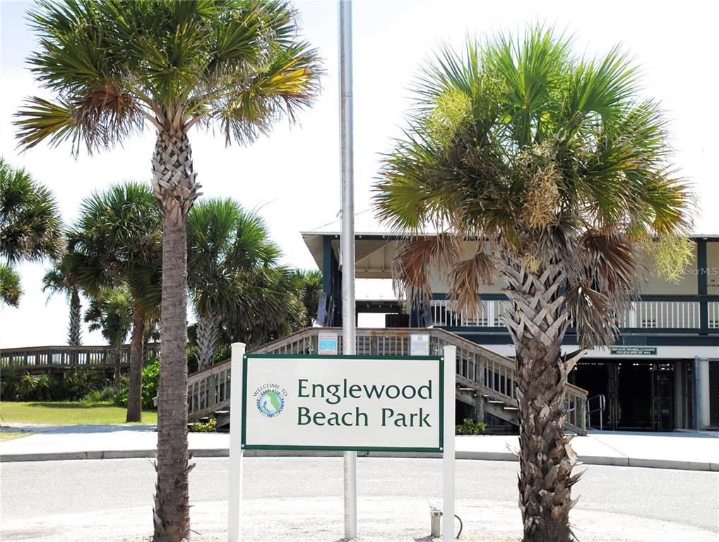 A sign for Englewood Beach Park stands between two palm trees in front of a building — 12087 CLAREMONT DRIVE, PORT CHARLOTTE, FL