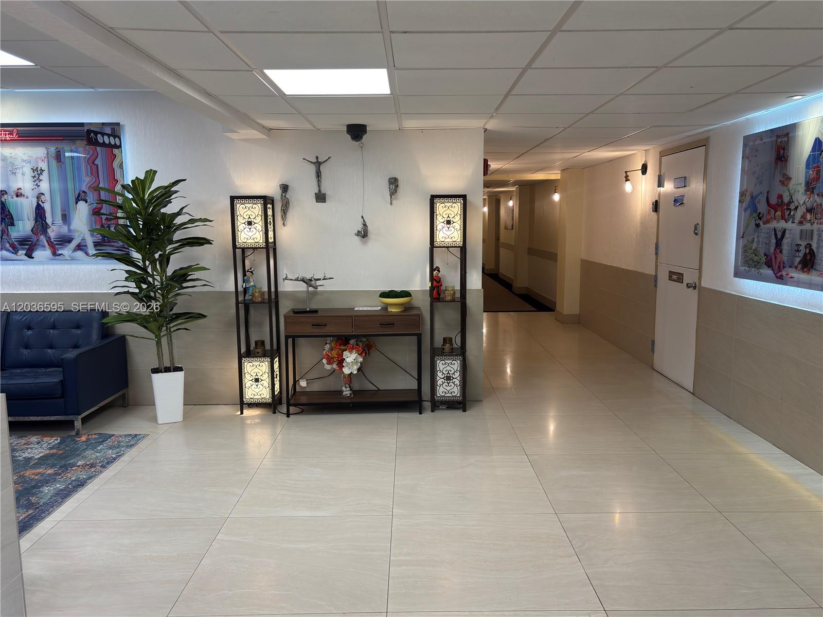 A modern kitchen features stainless steel appliances, dark lower cabinets, and white upper cabinets — 4164 INVERRARY DR # 1004, Lauderhill FL 33319, LAUDERHILL, FL