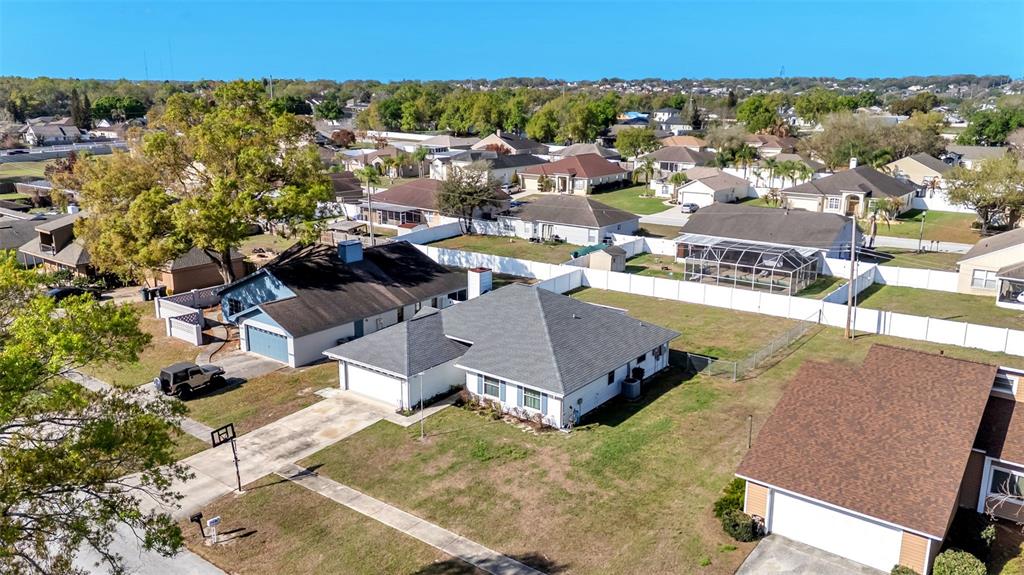 An aerial view shows several suburban houses with shingled roofs and fenced yards — 5249 NICHOLS DRIVE W, LAKELAND, FL