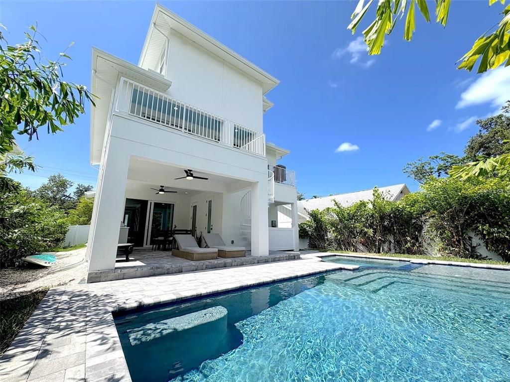 A white two-story house with a covered patio and a swimming pool in the backyard — 1647 SIESTA DRIVE, SARASOTA, FL