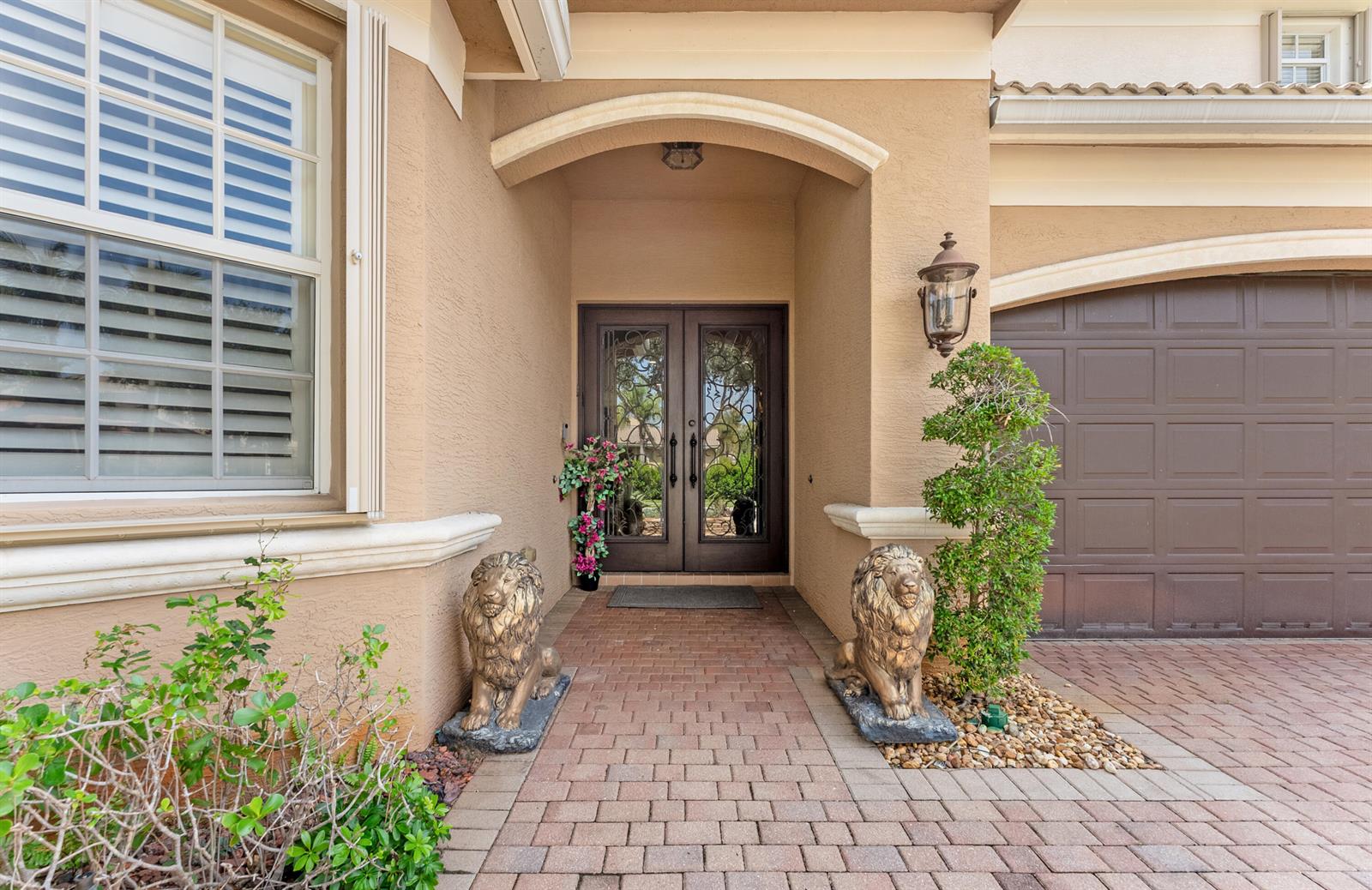 The exterior entrance features a brick walkway, double glass doors, and two lion statues — 11790 Foxbriar Lake Trail, Boynton Beach FL 33473, BOYNTON BEACH, FL