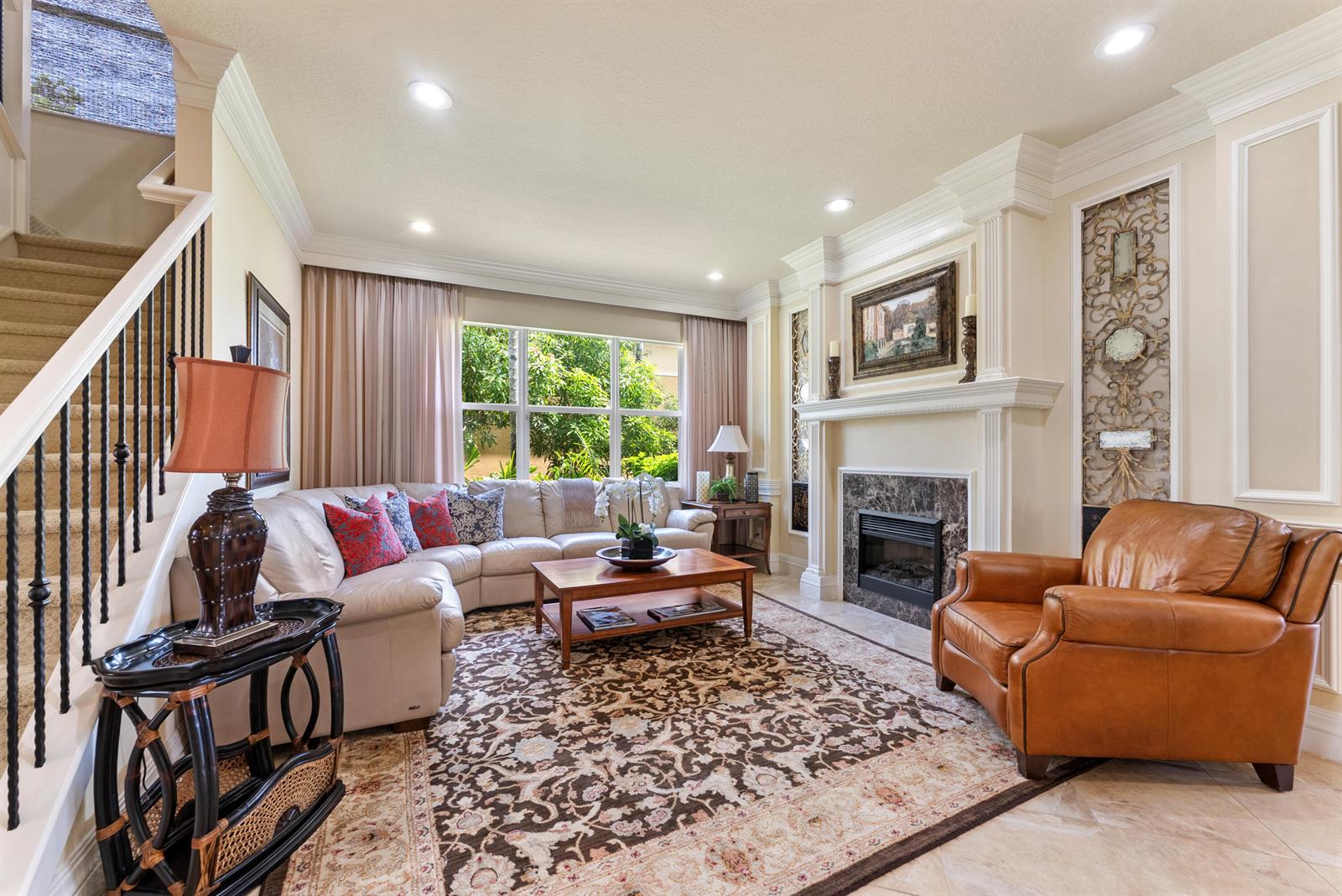 A living room features a fireplace, leather armchair, sectional sofa, and a staircase with railings — 11790 Foxbriar Lake Trail, Boynton Beach FL 33473, BOYNTON BEACH, FL