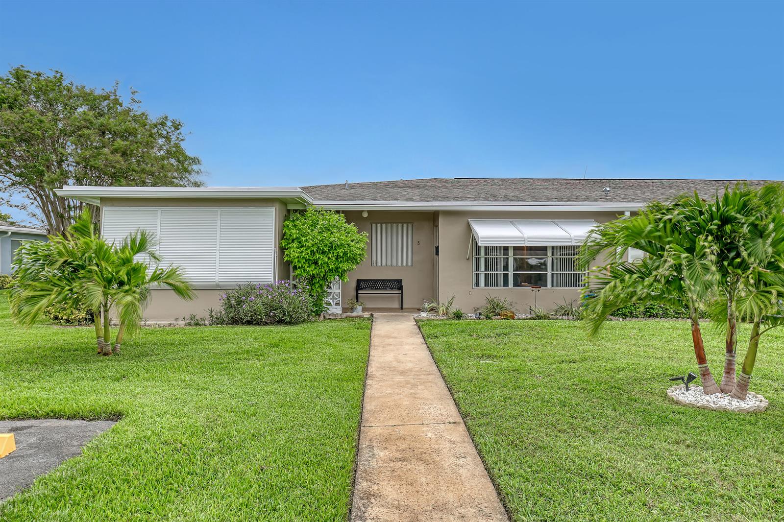 A single-story house with a beige exterior, a concrete walkway, and two palm trees — 245 Main Boulevard # B, Boynton Beach FL 33435, BOYNTON BEACH, FL