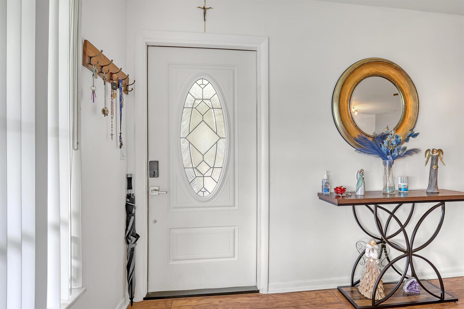 An entryway features a white front door with a glass insert, a mirror, and console table — 245 Main Boulevard # B, Boynton Beach FL 33435, BOYNTON BEACH, FL