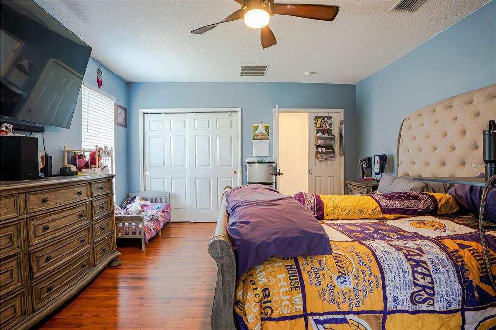 A bedroom features a Lakers-themed bed, a wooden dresser, and a small toddler bed — 1400 BENT OAKS BOULEVARD, DELAND, FL