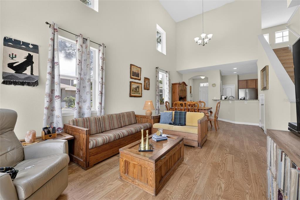 A living room with wood floors, a vaulted ceiling, and a wooden coffee table — 2130 BROADWAY VIEW AVENUE, BRANDON, FL