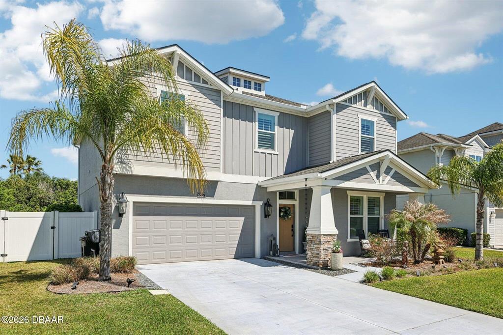 A two-story house with a gray exterior, a two-car garage, and a front porch — 6827 FORKMEAD LANE, PORT ORANGE, FL
