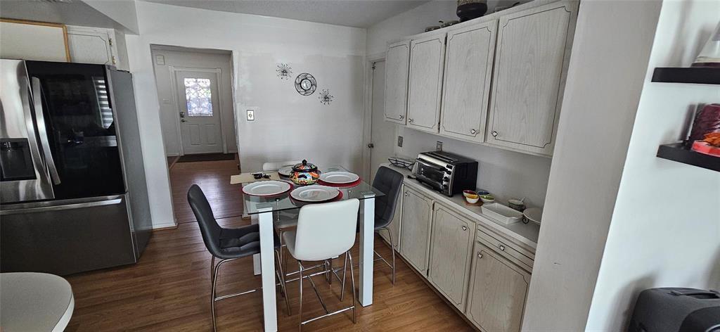 A kitchen dining area features light wood cabinets, a glass-top table, and stainless steel appliances — 7000 NW 11th Street, Margate FL 33063, MARGATE, FL