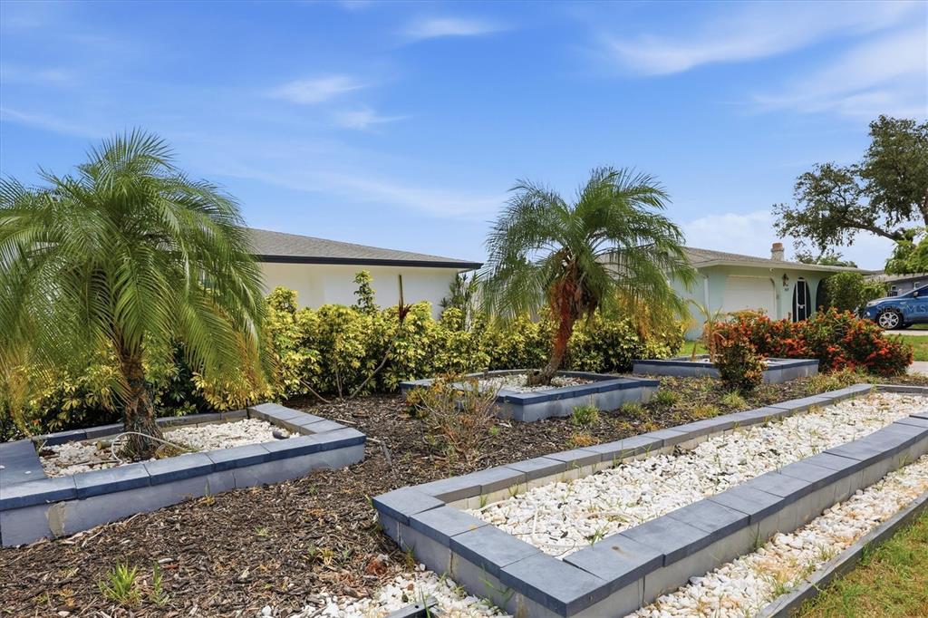 An aerial view shows a house with a screened pool, patio, and waterfront backyard — 3615 EGERTON CIRCLE, SARASOTA, FL