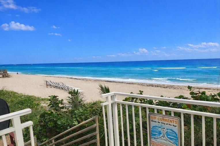 A view of a sandy beach and ocean from a white railed balcony — 3475 S Ocean Boulevard # 3020, Palm Beach FL 33480, PALM BEACH, FL
