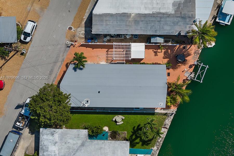 An aerial view shows a house with a gray roof, a patio, and a backyard — 605 26th Street Ocean, Marathon FL 33050, MARATHON, FL