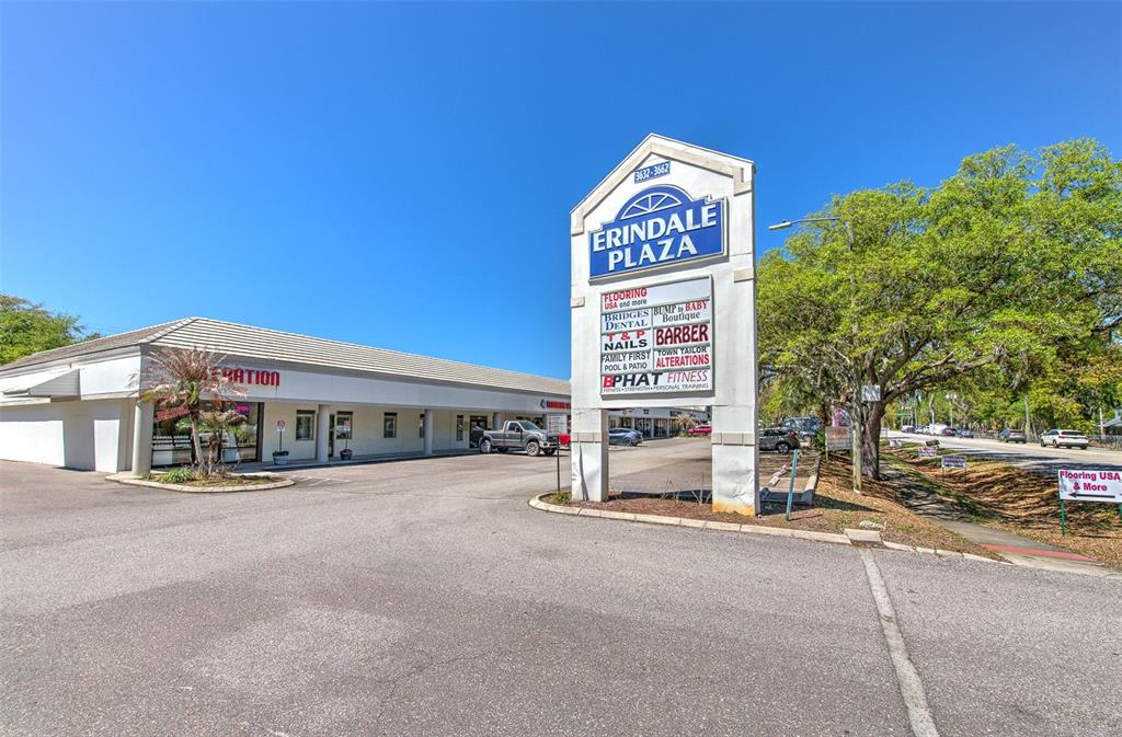 A commercial strip mall features a prominent monument sign and a paved parking lot — 3662 LITHIA PINECREST ROAD, VALRICO, FL