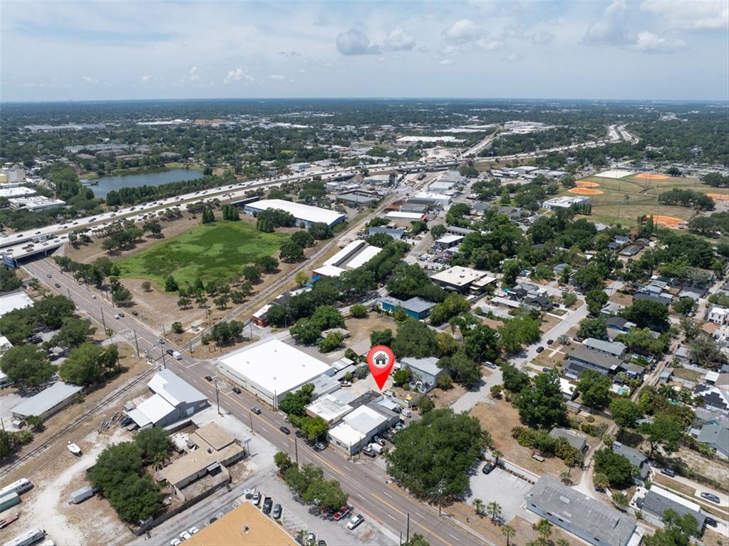 An aerial view shows a commercial building marked with a red pin near a highway — 1763 9TH AVENUE N, ST PETERSBURG, FL