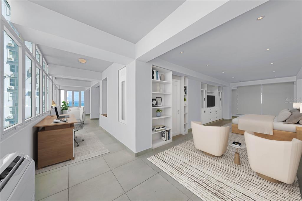 A modern bedroom features a desk area, white built-in shelving, and a view of the ocean — 8 MANUEL RODRIGUEZ SERRA STREET UNIT 2B, SAN JUAN, PR