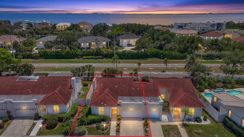 An aerial view shows a single-story house with a red tile roof and attached garage — 4904 61ST AVENUE TERRACE W, BRADENTON, FL