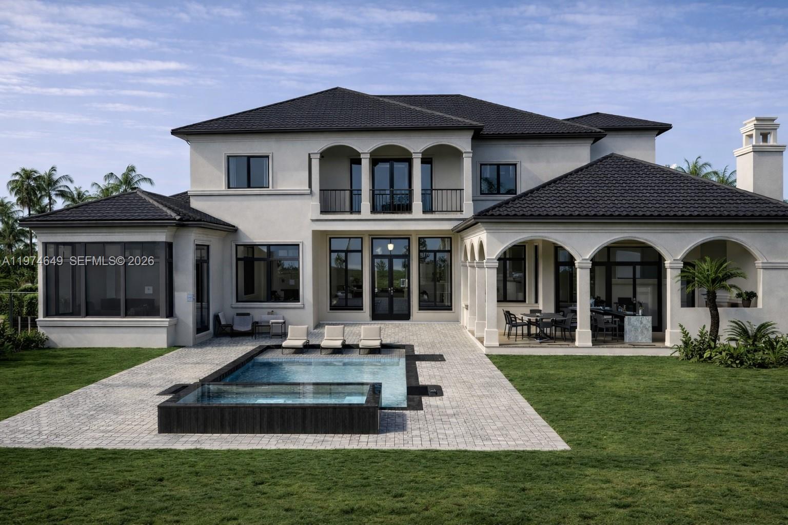 A two-story Mediterranean-style house with a dark tile roof, circular driveway, and central fountain — 751 Ranch Rd, Weston FL 33326, WESTON, FL
