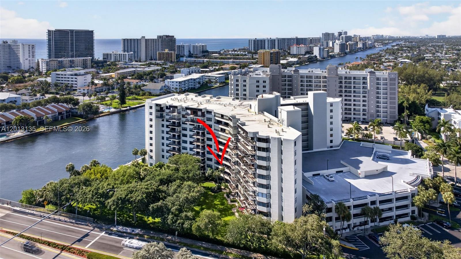 An aerial view shows a multi-story residential building situated along a canal — 2900 NE 14th St Cswy # 304, Pompano Beach FL 33062, POMPANO BEACH, FL