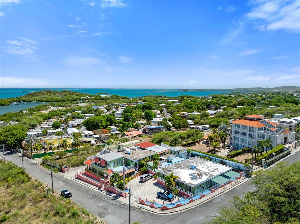 An aerial view shows a multi-story building with a flat roof and a parking area — #3 CARR 304, LAJAS, PR