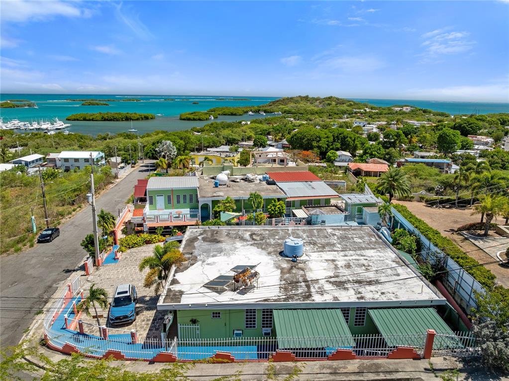 An aerial view shows a green multi-level building with a flat roof and fenced yard — #3 CARR 304, LAJAS, PR