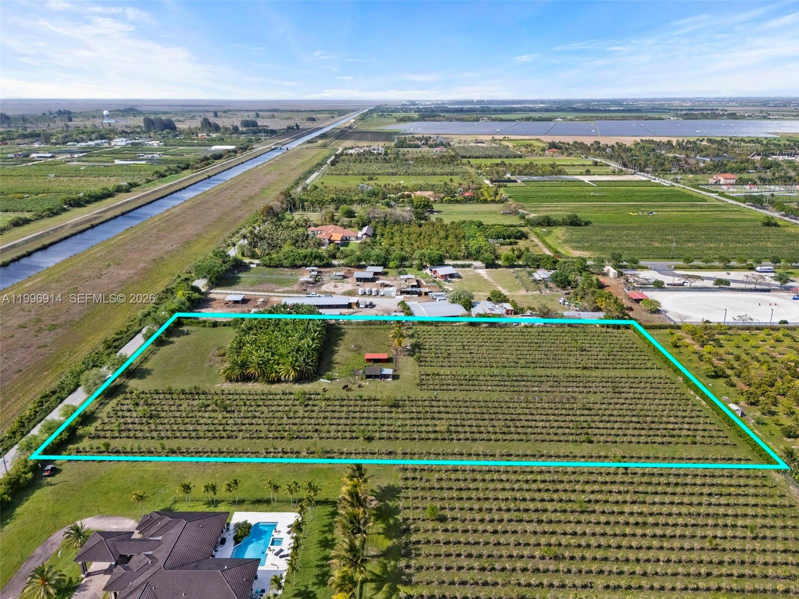 An aerial view shows a large rectangular agricultural plot outlined in blue with small structures — 14651 SW 187 Ave, Miami FL 33196, MIAMI, FL