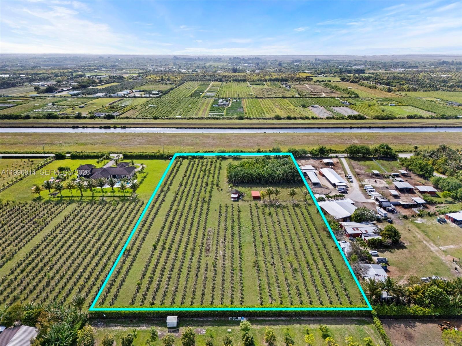 An aerial view shows a rectangular agricultural plot with rows of crops and small structures — 14651 SW 187 Ave, Miami FL 33196, MIAMI, FL
