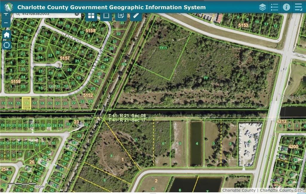 This is a GIS map showing property parcel boundaries, roads, and vegetation in Charlotte County — 7704 ST REGIS CIRCLE, PORT CHARLOTTE, FL