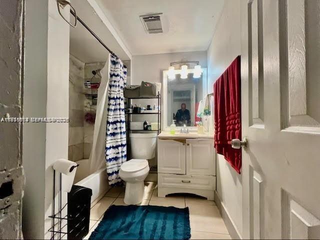A bathroom features a white vanity, a toilet, a shower-tub combo, and red towels — 12890 NE 8th Ave # 102, North Miami FL 33161, NORTH MIAMI, FL
