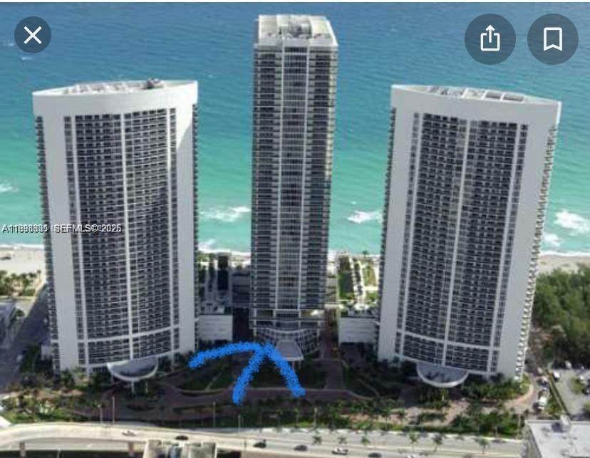 An aerial view shows three tall residential towers situated along a sandy beach — 1830 S Ocean Dr # 2011, Hallandale Beach FL 33009, HALLANDALE BEACH, FL
