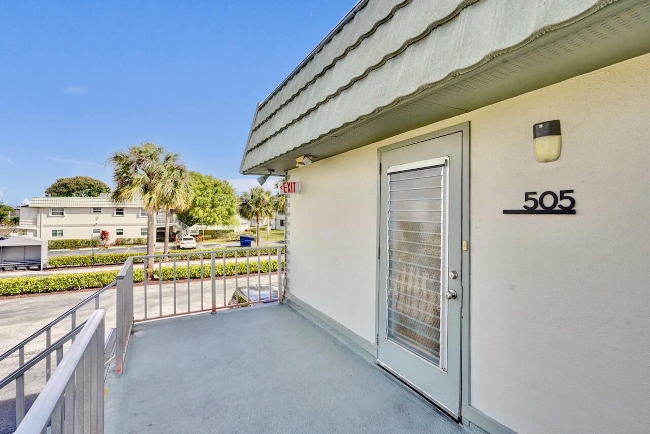 An exterior view of a balcony leading to a door marked with the number 505 — 505 Monaco K, Delray Beach FL 33446, DELRAY BEACH, FL
