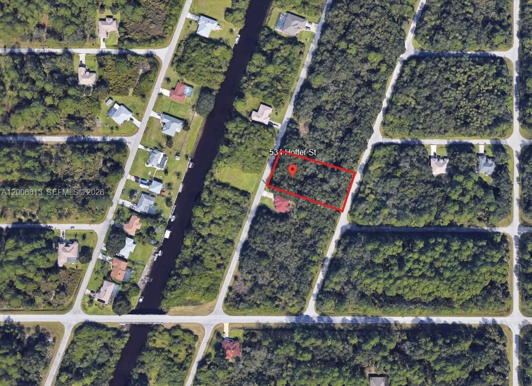 This aerial map shows a vacant, wooded residential lot outlined in red — 534 Hoffer, Port Charlotte FL 33953, PORT CHARLOTTE, FL
