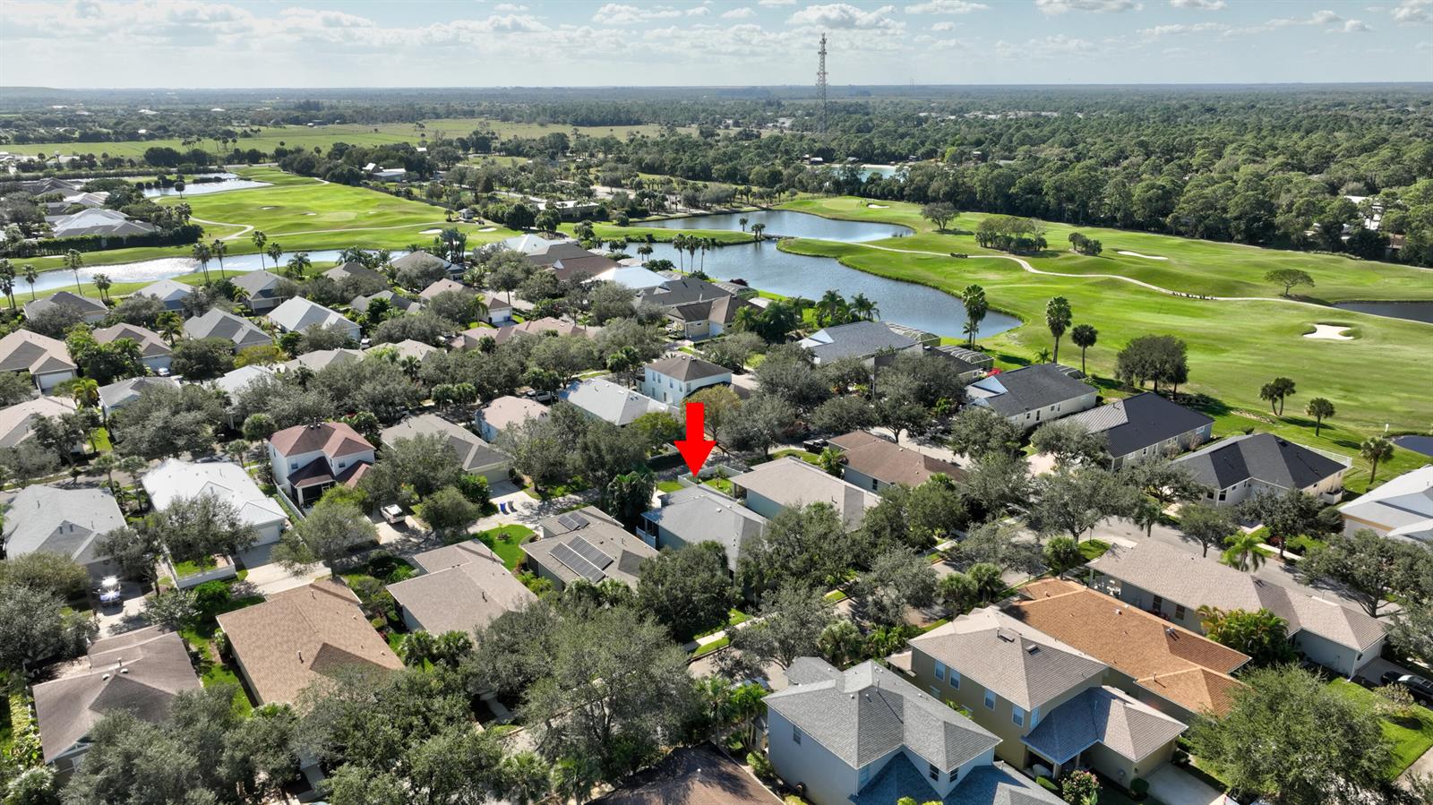 An aerial view shows a residential neighborhood with houses, trees, and a golf course — 7865 15th Lane, Vero Beach FL 32966, VERO BEACH, FL