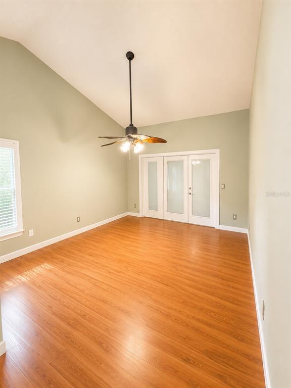 A view from a wooden staircase looking down into an entryway and living area — 1004 MUIRFIELD COURT, OVIEDO, FL