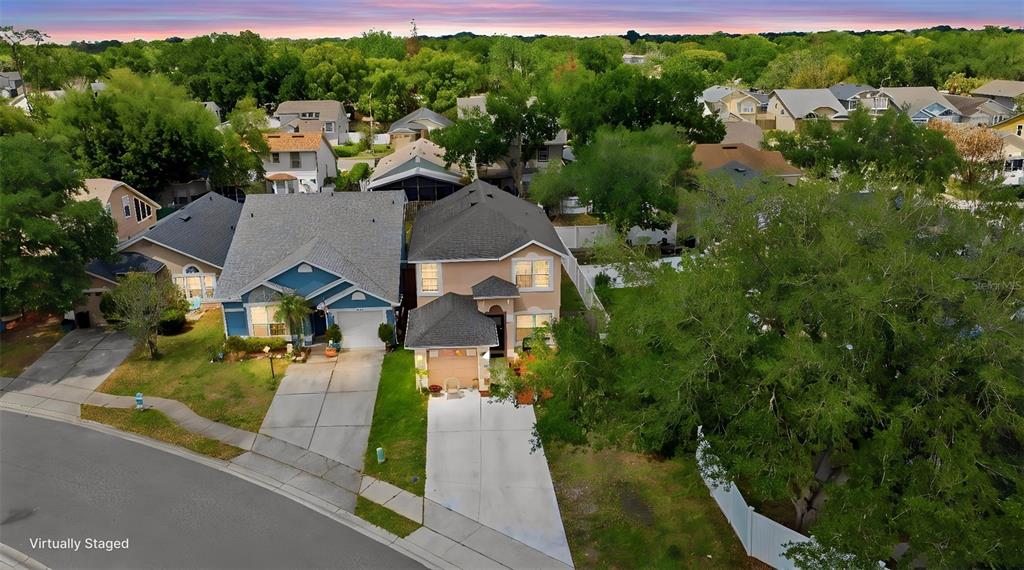 An aerial view shows two suburban houses with driveways and lawns at sunset — 3440 ALLSTON LANE, WINTER PARK, FL