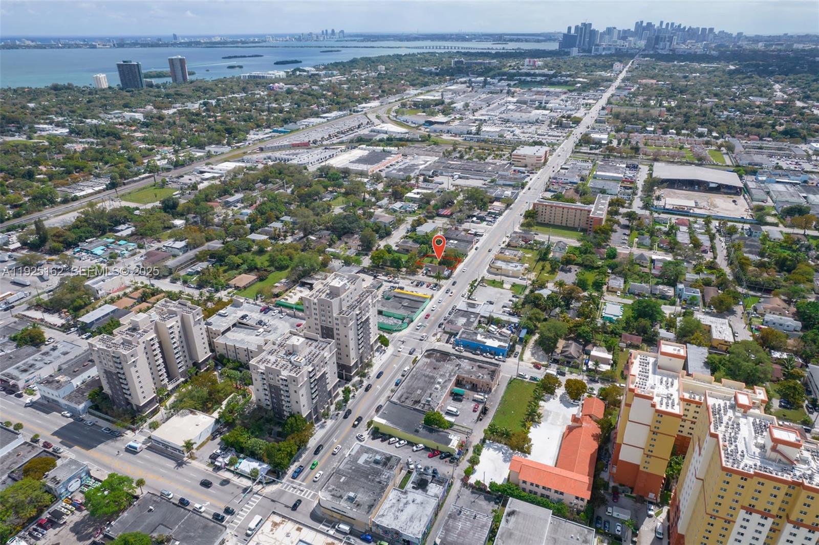 This aerial view shows a city neighborhood with a red location pin on a building — 7635 NE 2nd Ave, Miami FL 33138, MIAMI, FL