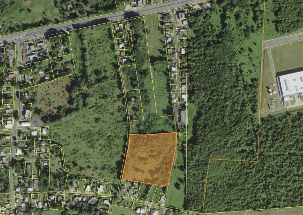 An aerial map shows a highlighted rectangular plot of land surrounded by trees and houses — BARRIO CEIBA BAJA, AGUADILLA, PR