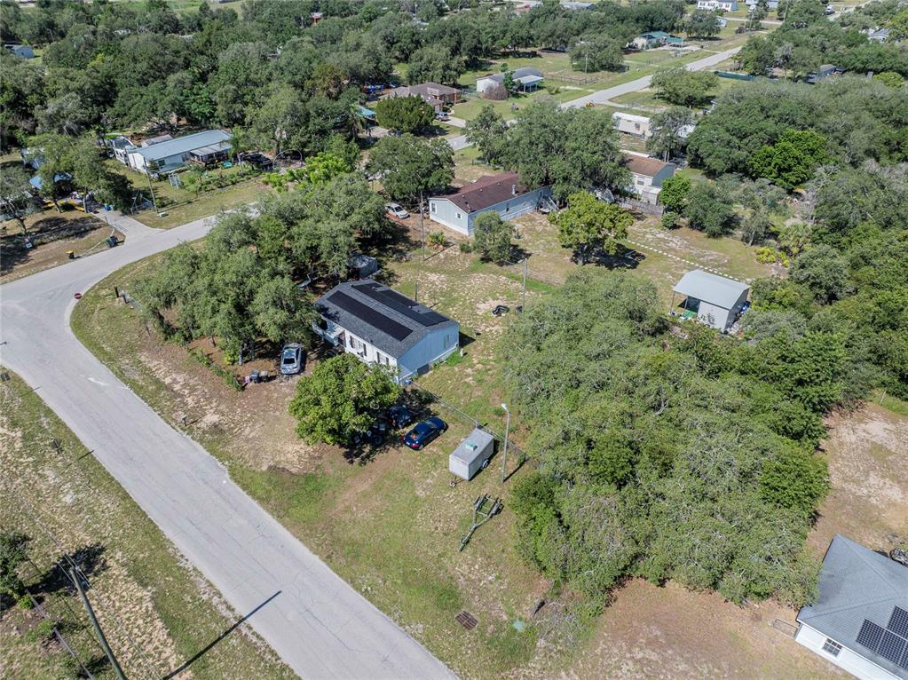 An aerial view shows a residential property with a house, detached shed, and surrounding trees — 3825 CARRIAGE DRIVE, LAKE WALES, FL